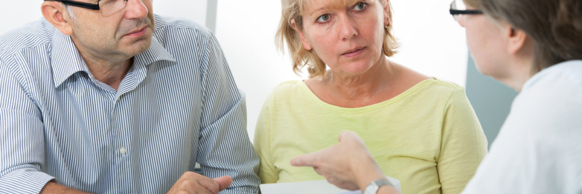 White woman advising older white man woman