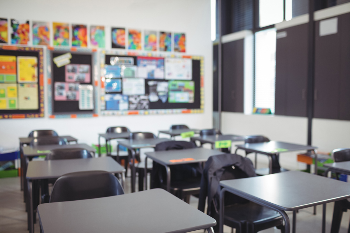 Empty classroom desks chairs wall display